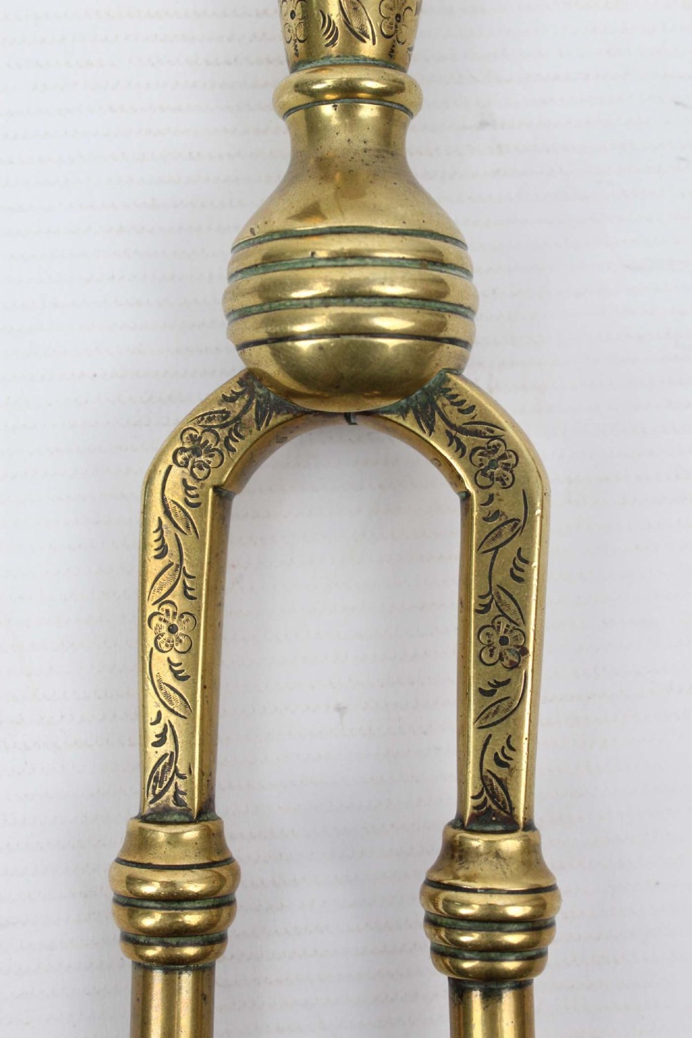A three-piece set of Victorian brass fire tools consisting of a shovel, a poker, and tongs with turned and engraved handles. View III