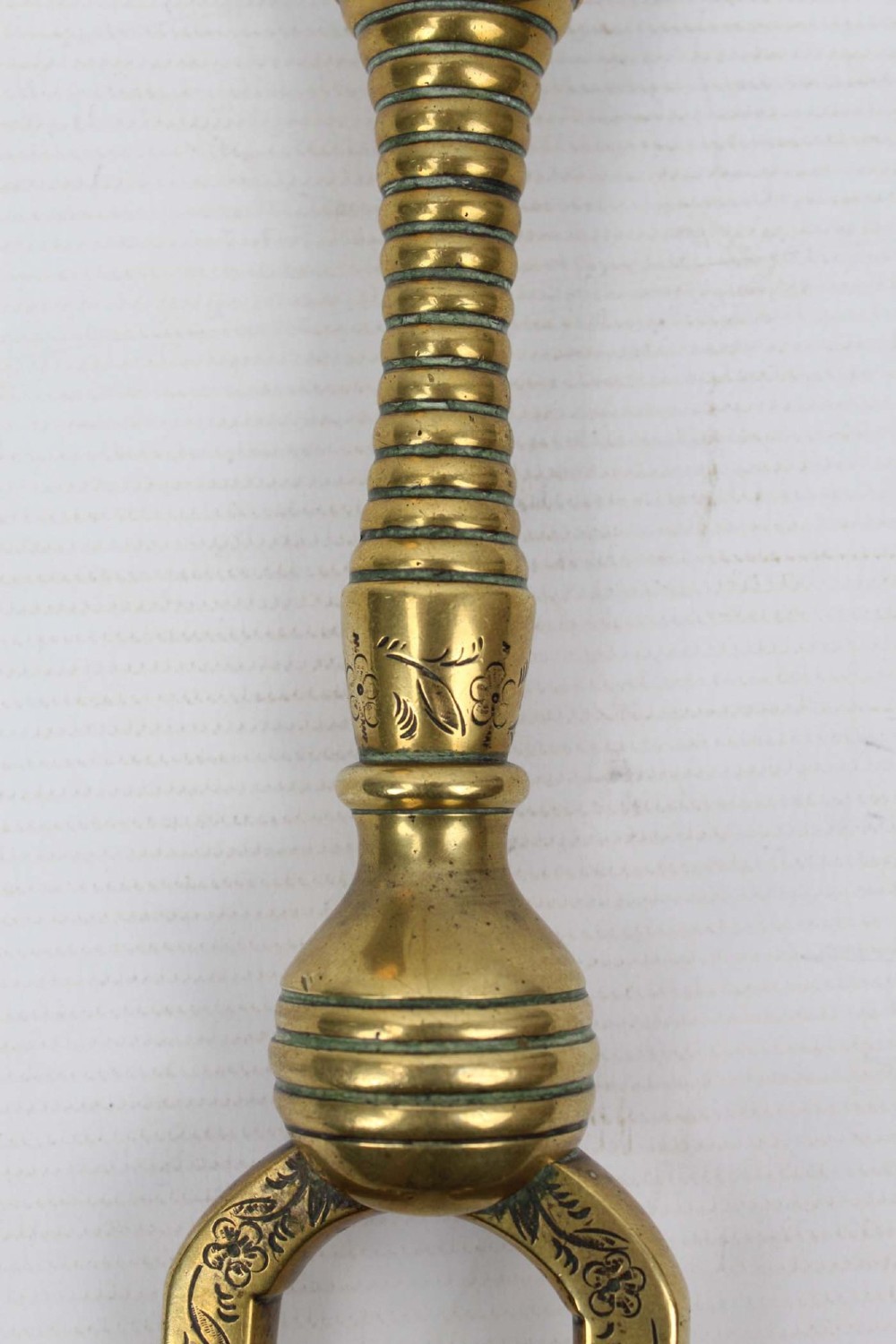 A three-piece set of Victorian brass fire tools consisting of a shovel, a poker, and tongs with turned and engraved handles. View IV