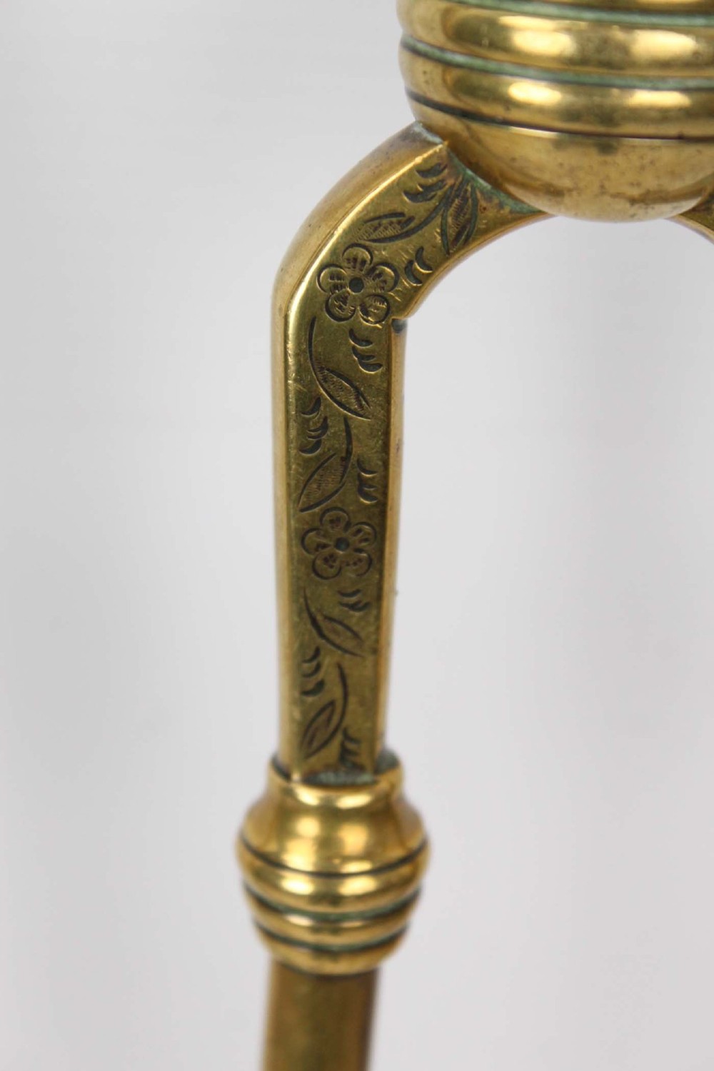 A three-piece set of Victorian brass fire tools consisting of a shovel, a poker, and tongs with turned and engraved handles. View VII