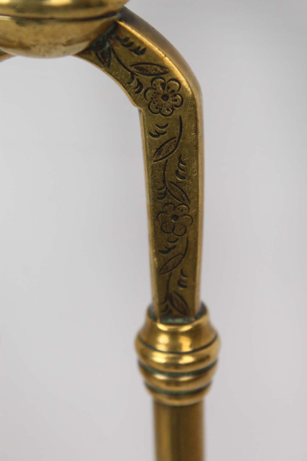 A three-piece set of Victorian brass fire tools consisting of a shovel, a poker, and tongs with turned and engraved handles. View VIII