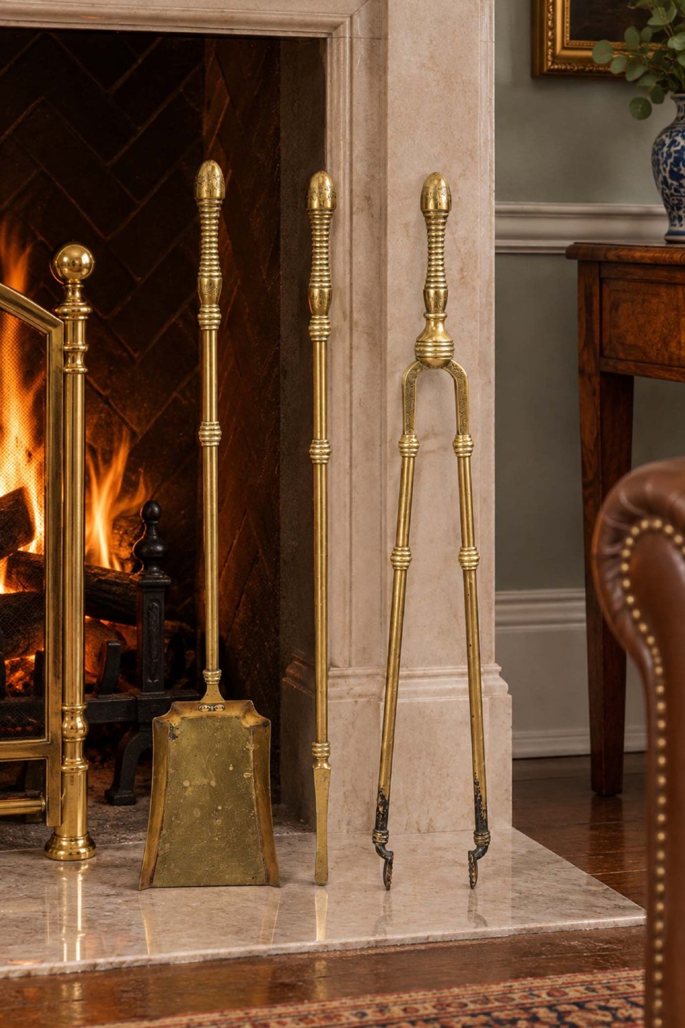 A three-piece set of Victorian brass fire tools consisting of a shovel, a poker, and tongs with turned and engraved handles. View XIII