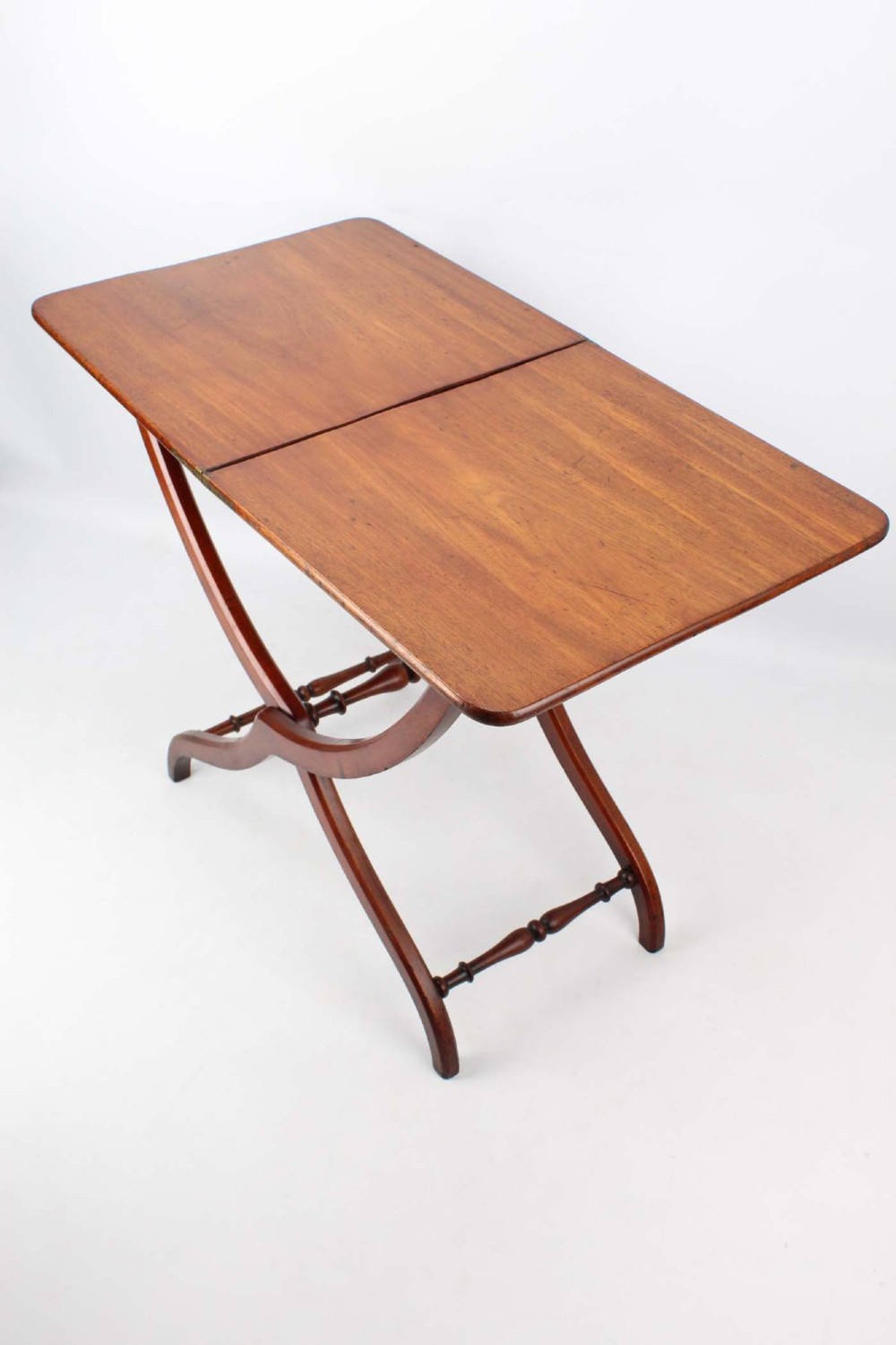 A Victorian mahogany coaching table featuring a rectangular folding top supported by curved X-frame legs and turned stretchers. View III