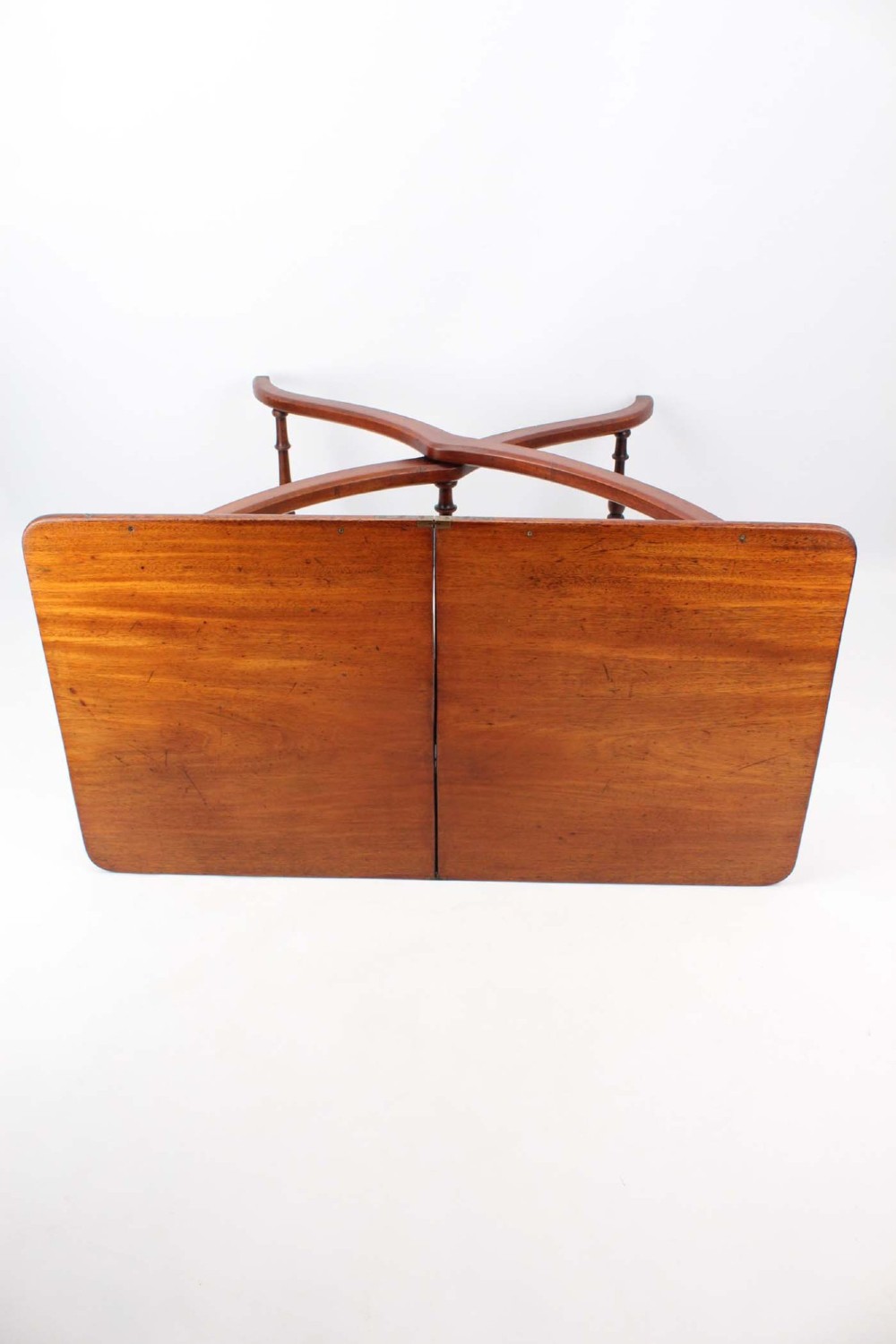 A Victorian mahogany coaching table featuring a rectangular folding top supported by curved X-frame legs and turned stretchers. View IV
