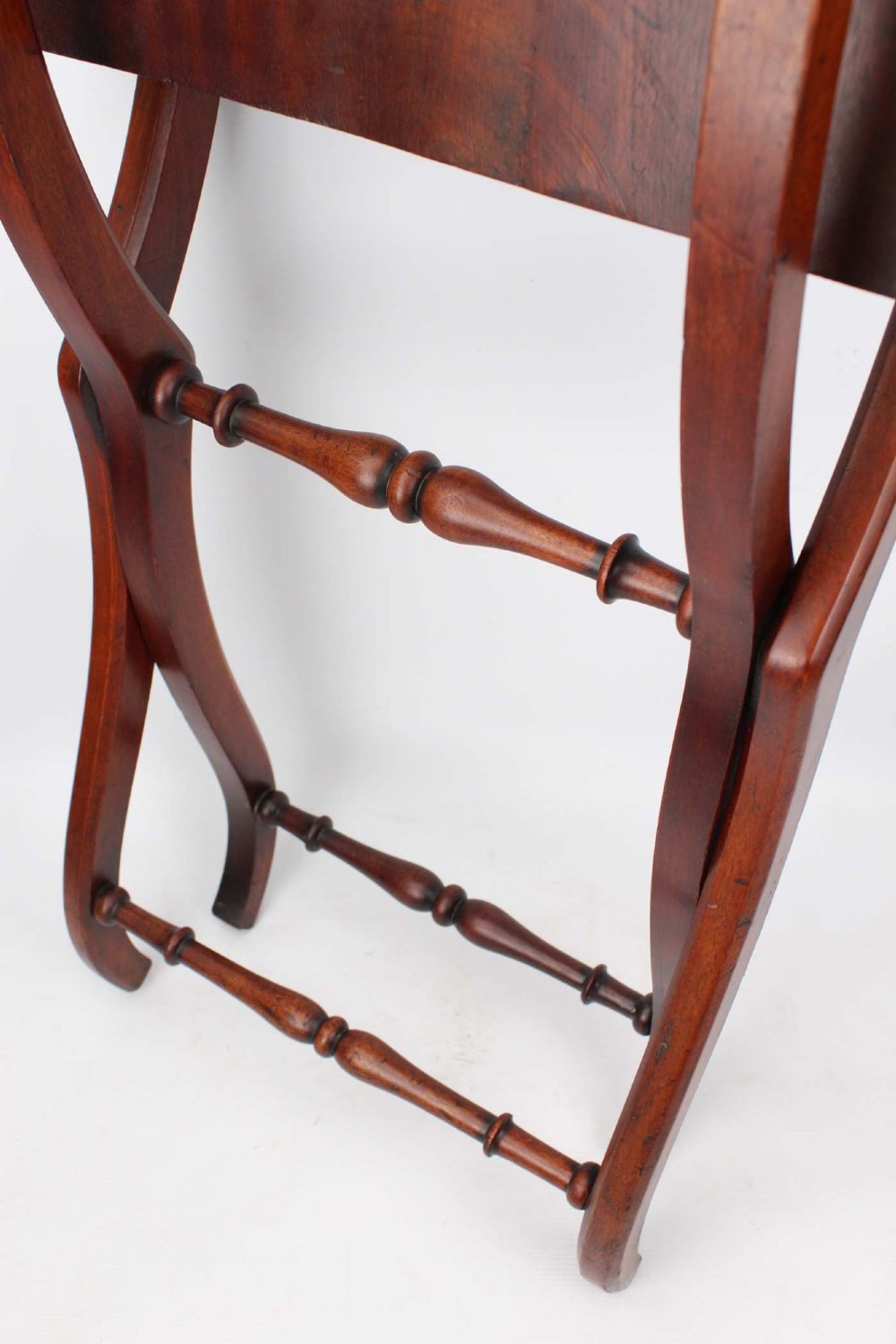 A Victorian mahogany coaching table featuring a rectangular folding top supported by curved X-frame legs and turned stretchers. View X