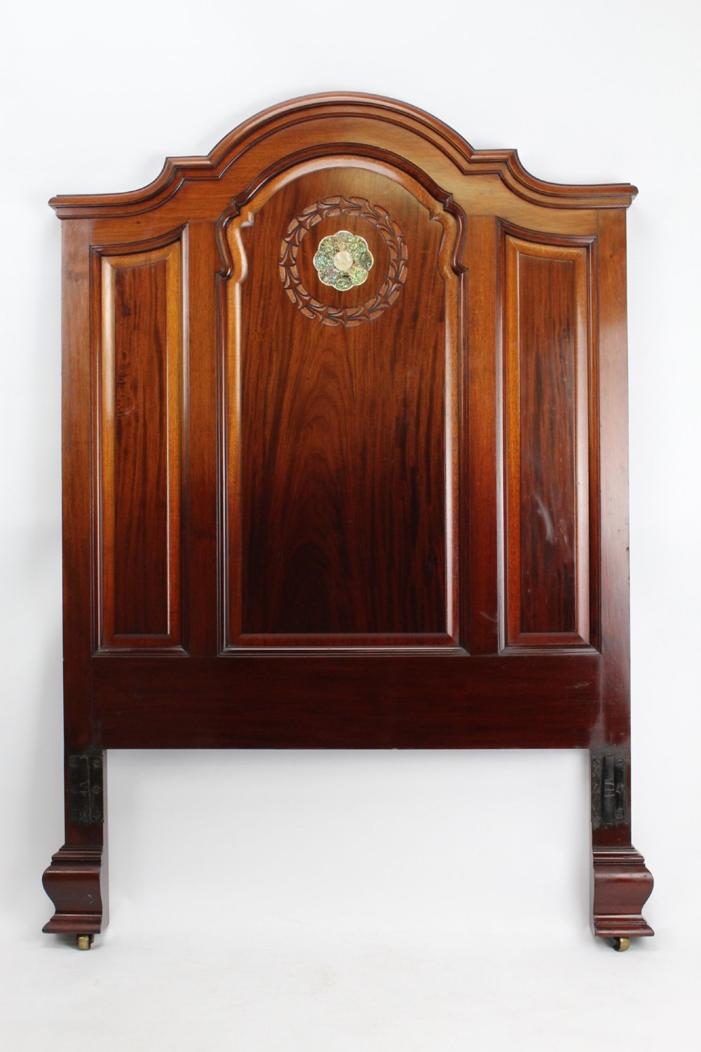 A Victorian walnut single bedstead featuring arched panels, carved circular wreaths, and central mother-of-pearl and abalone shell floral inlays. View III