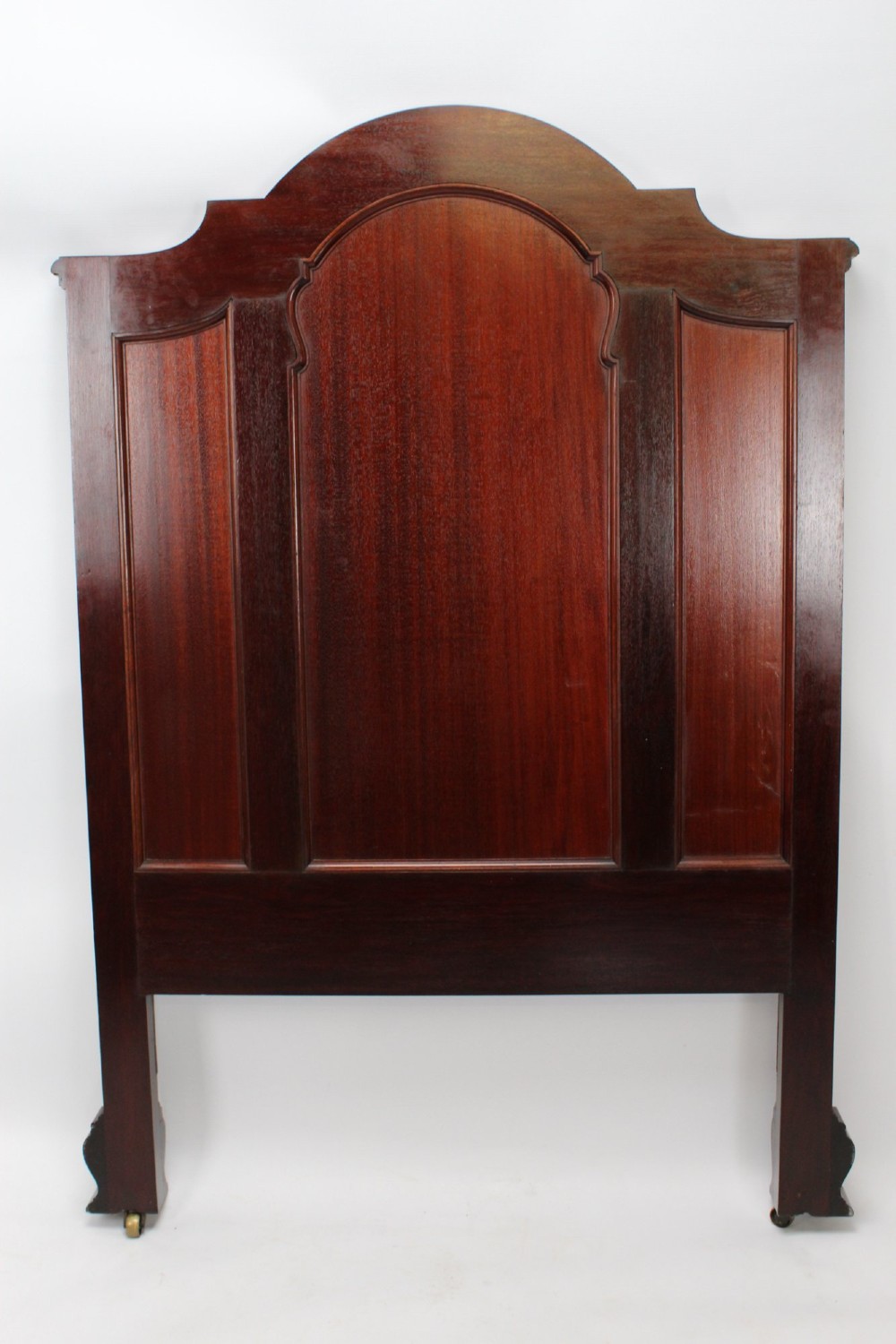 A Victorian walnut single bedstead featuring arched panels, carved circular wreaths, and central mother-of-pearl and abalone shell floral inlays. View IV