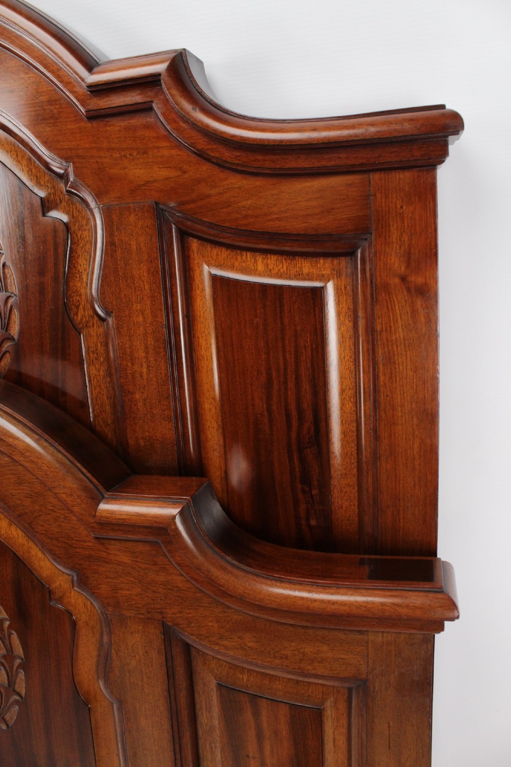 A Victorian walnut single bedstead featuring arched panels, carved circular wreaths, and central mother-of-pearl and abalone shell floral inlays. View IX