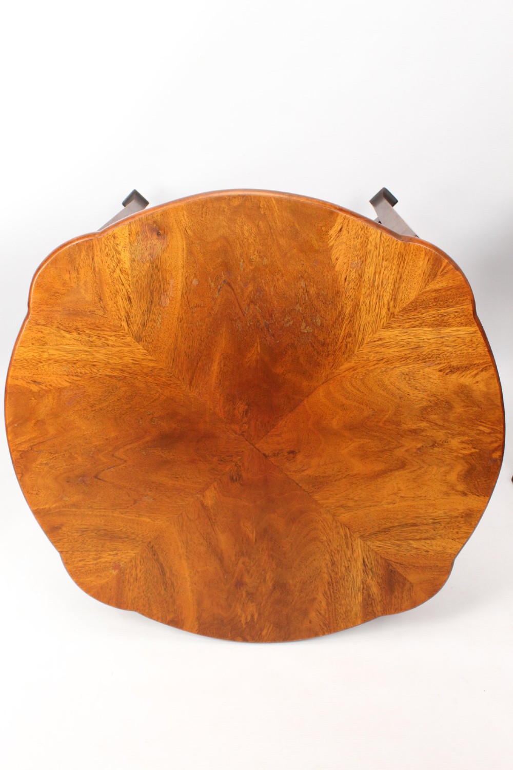 An Art Deco warm brown walnut circular coffee table featuring four sector-shaped nesting side tables stowed underneath. View IV