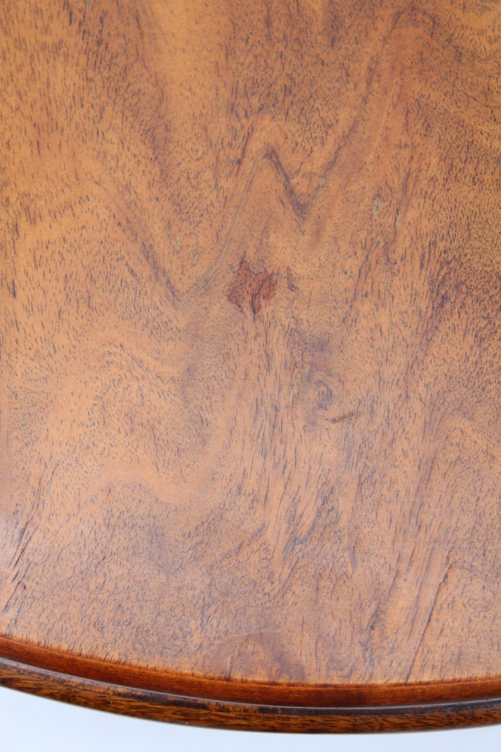 An Art Deco warm brown walnut circular coffee table featuring four sector-shaped nesting side tables stowed underneath. View V