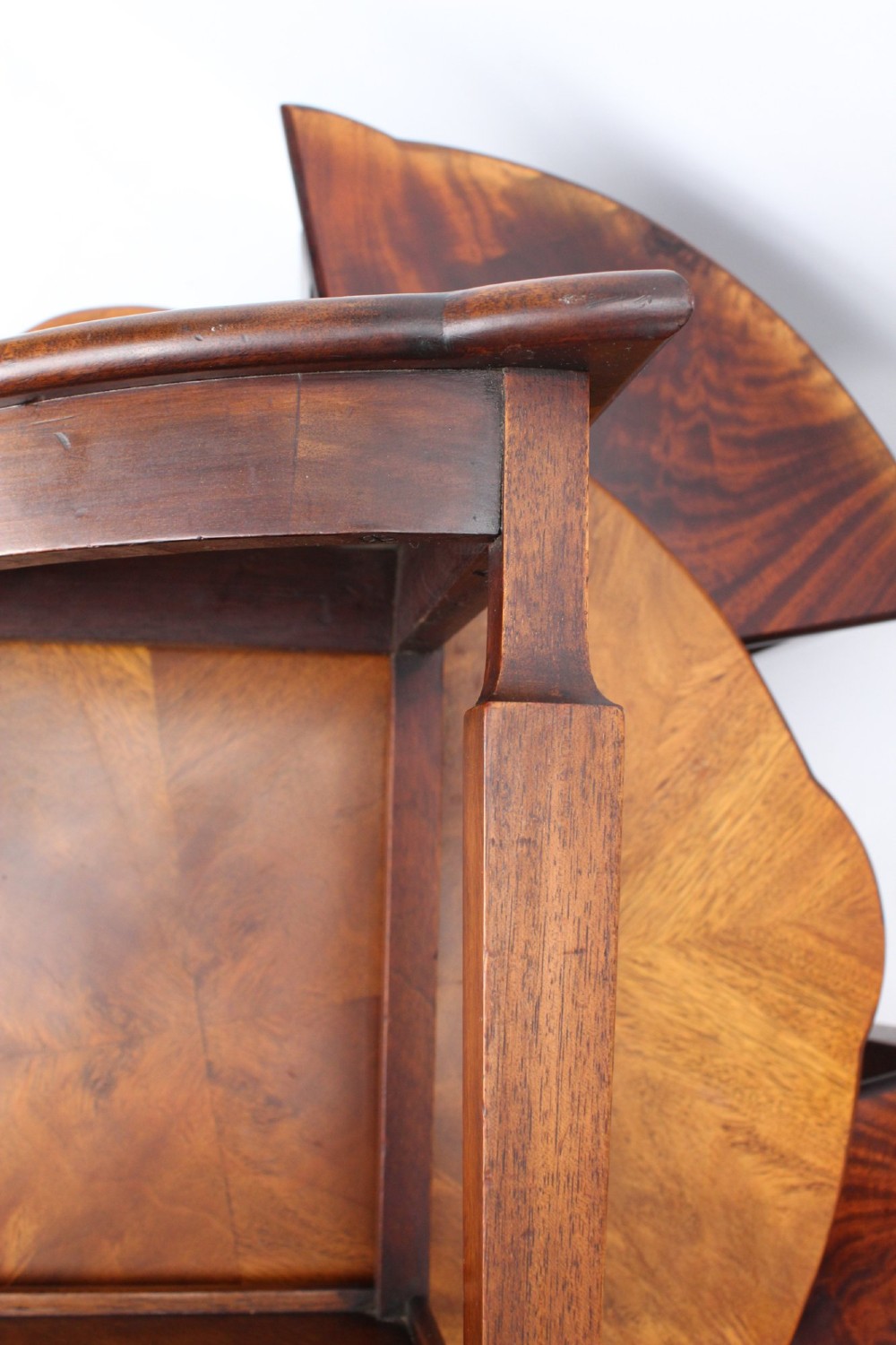 An Art Deco warm brown walnut circular coffee table featuring four sector-shaped nesting side tables stowed underneath. View X