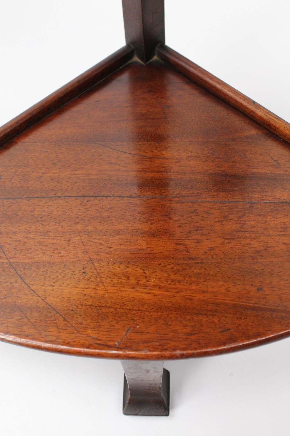 An Art Deco warm brown walnut circular coffee table featuring four sector-shaped nesting side tables stowed underneath. View XII