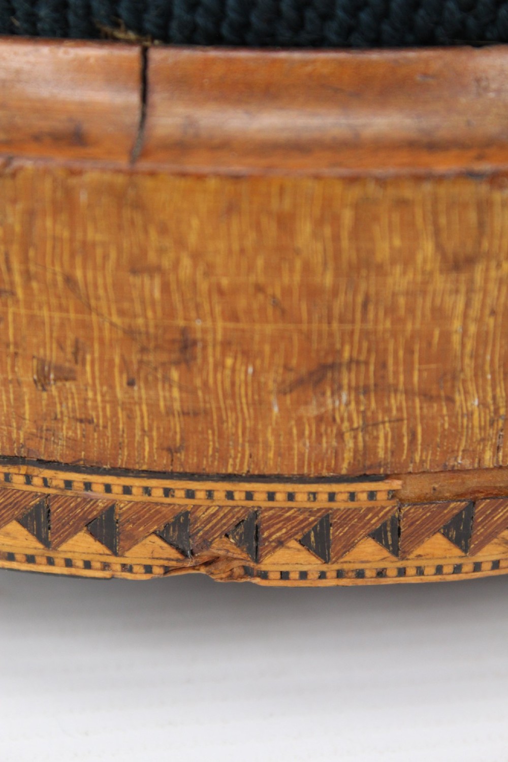 A pair of circular Early Victorian footstools featuring teal floral needlepoint tops within light wood frames and geometric mosaic borders. View XII