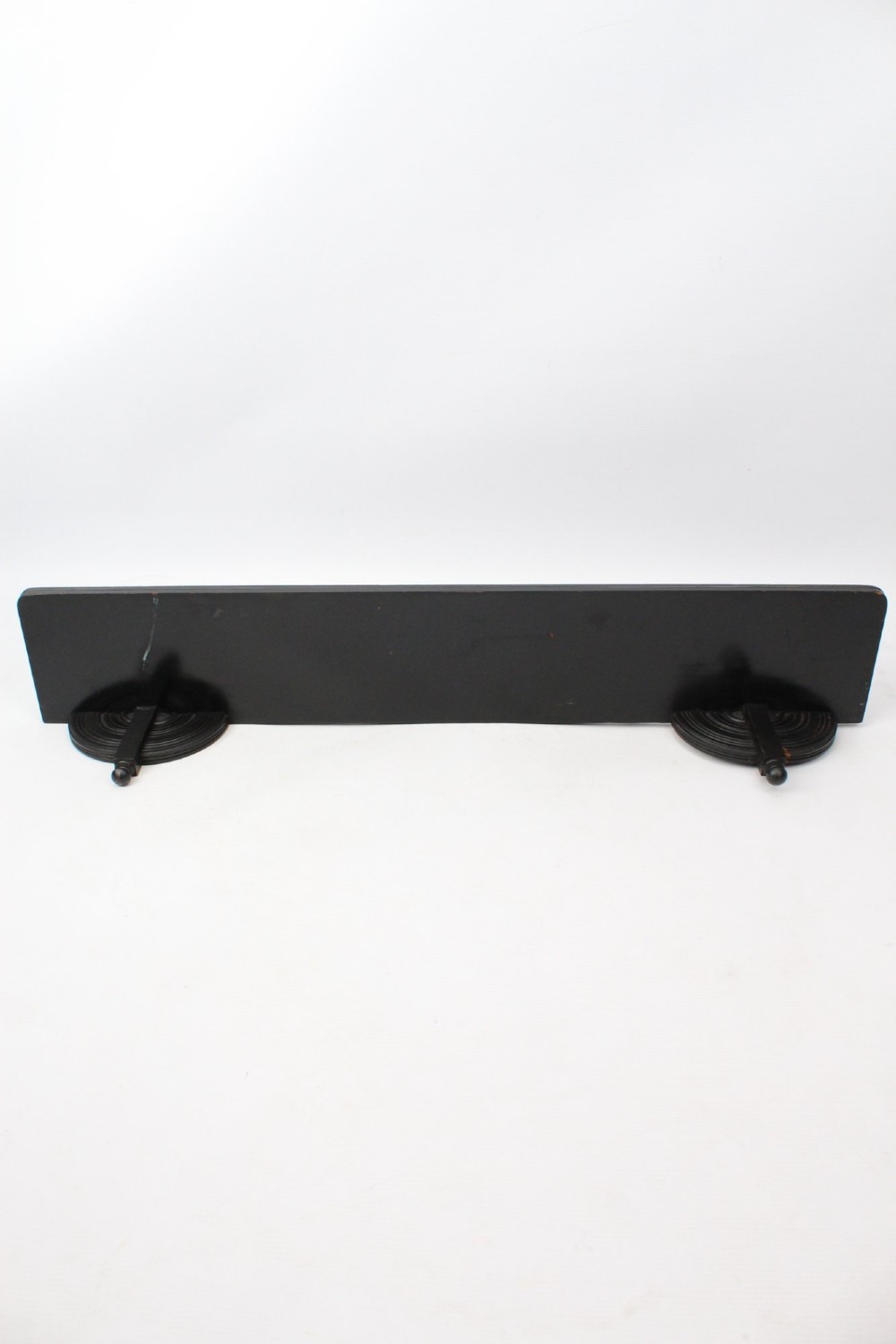 An ebonised wooden hanging wall shelf featuring a low spindle balustrade rail, turned finials, and decorative corner mouldings. View VIII