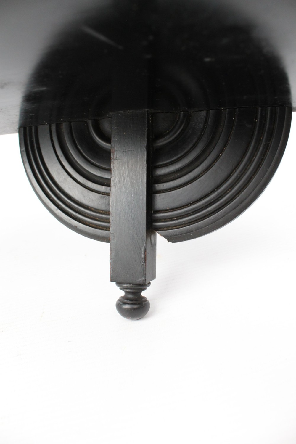 An ebonised wooden hanging wall shelf featuring a low spindle balustrade rail, turned finials, and decorative corner mouldings. View XII