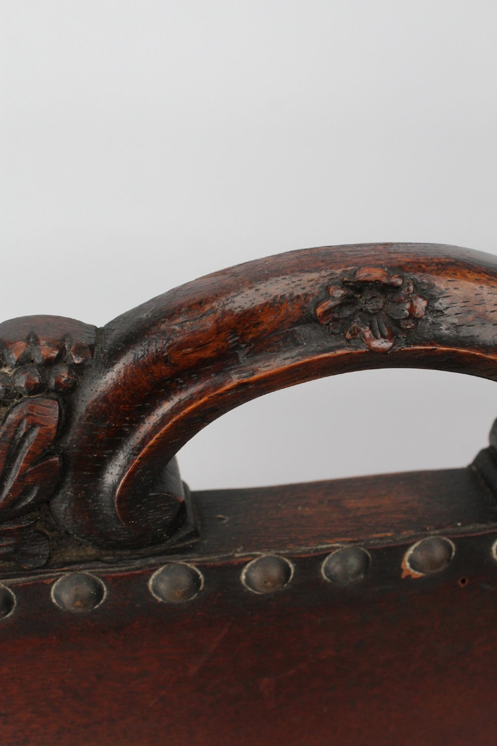 An Edwardian Arts and Crafts fire screen constructed from carved oak and warm brown leather featuring brass studwork and a central oval motif. View XI