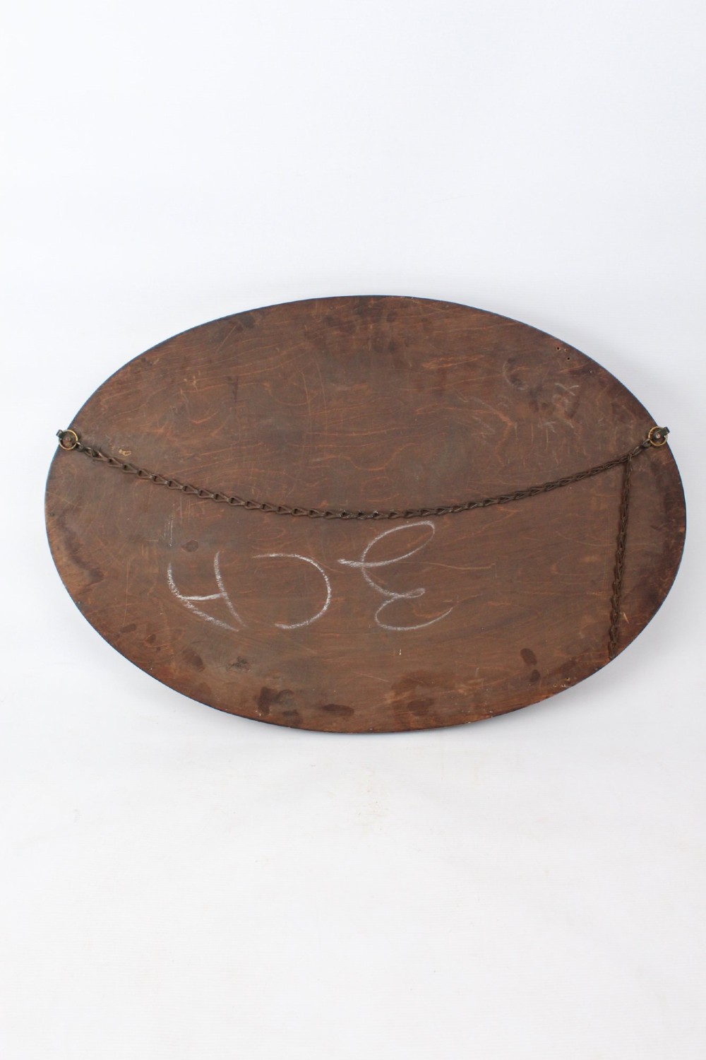 An Edwardian oval wall mirror featuring a carved dark oak frame decorated with leaf motifs and rounded bosses. View XIII
