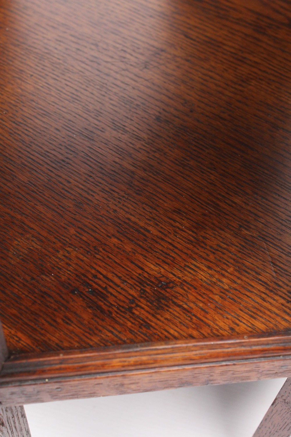 An Edwardian hexagonal dark oak side table featuring intricate relief carving on the top surface and side panels. View XI