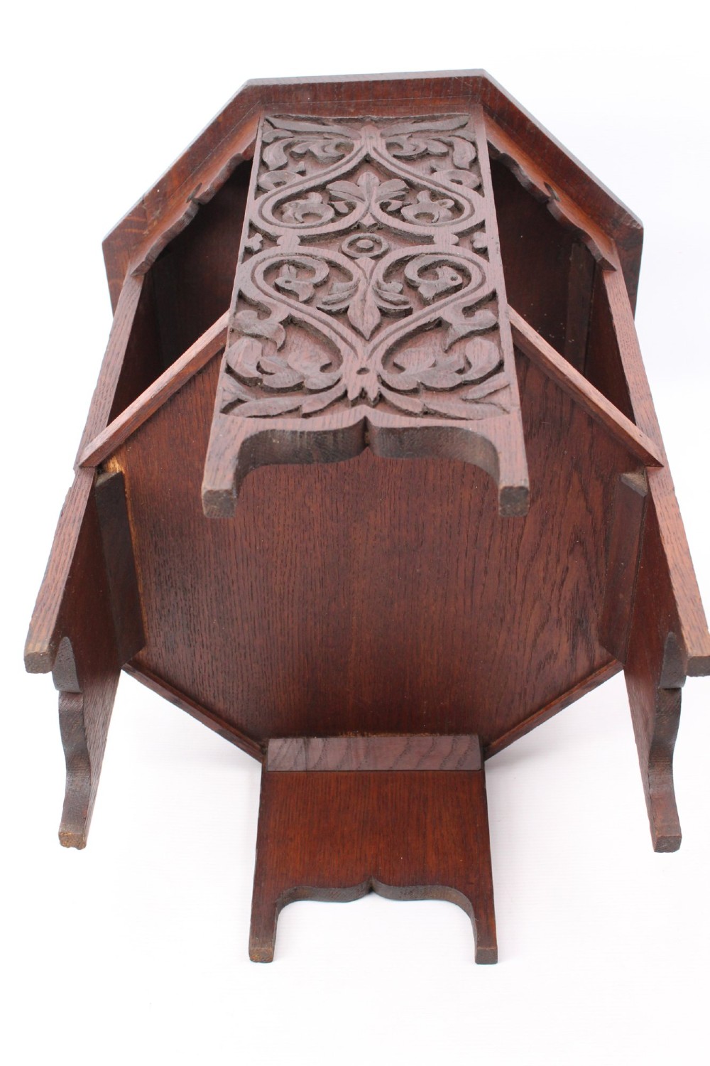 An Edwardian hexagonal dark oak side table featuring intricate relief carving on the top surface and side panels. View XII