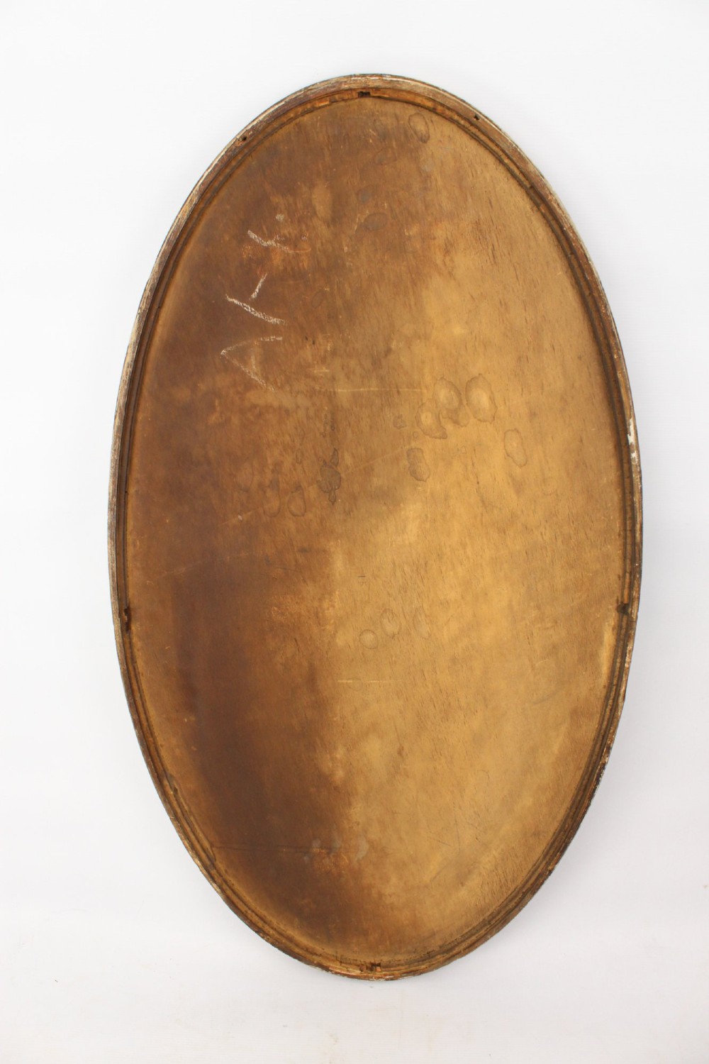 A large Victorian oval wall mirror featuring a gilded reeded frame with decorative cross-ribbon accents at four points. View XI
