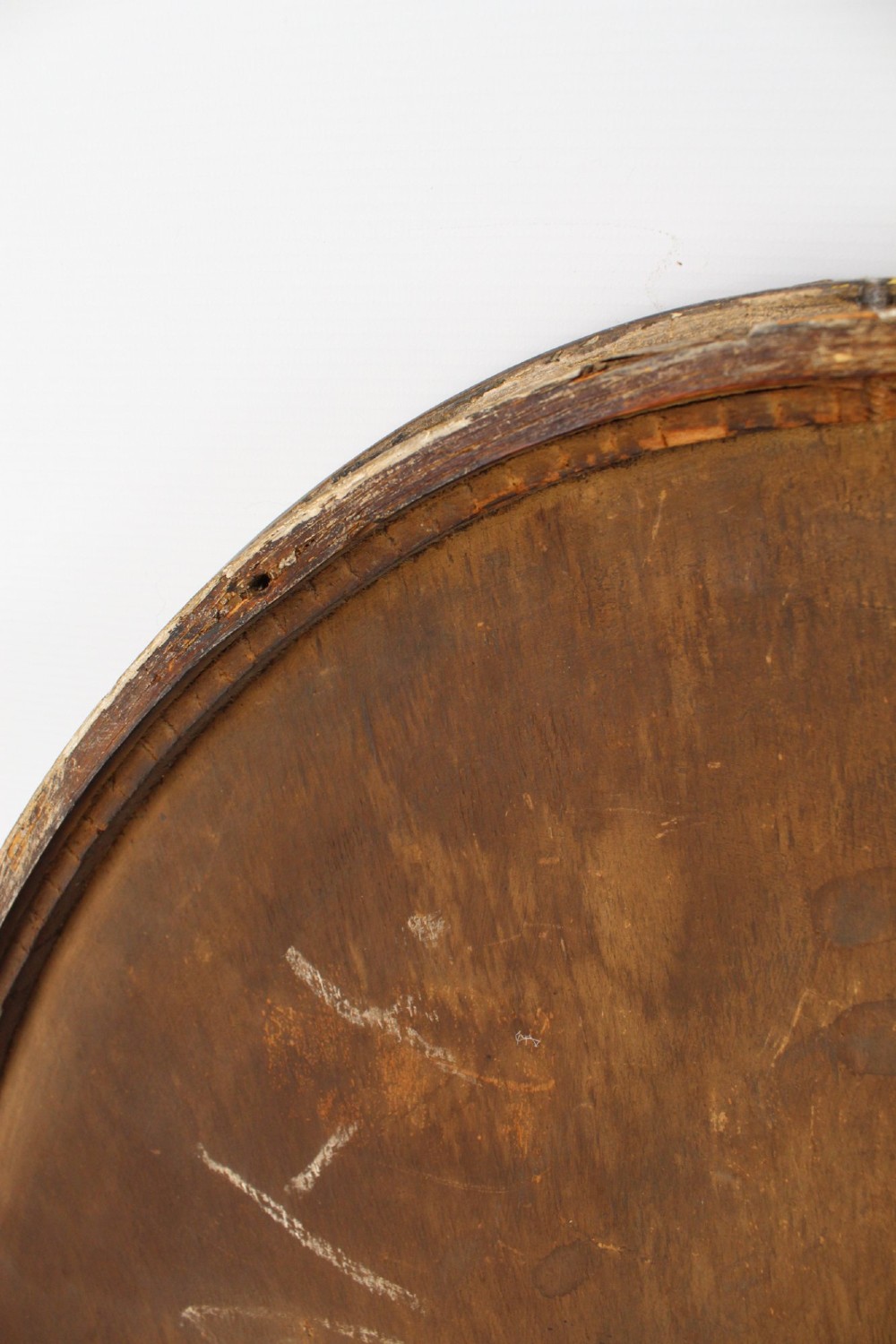 A large Victorian oval wall mirror featuring a gilded reeded frame with decorative cross-ribbon accents at four points. View XII