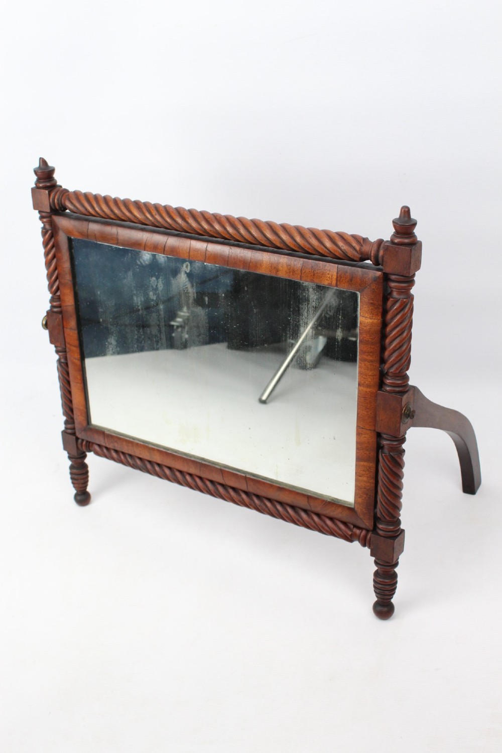 An antique Regency mahogany toilet mirror featuring a swivelling rectangular glass frame supported by rope-twist turned pillars with finials. View III