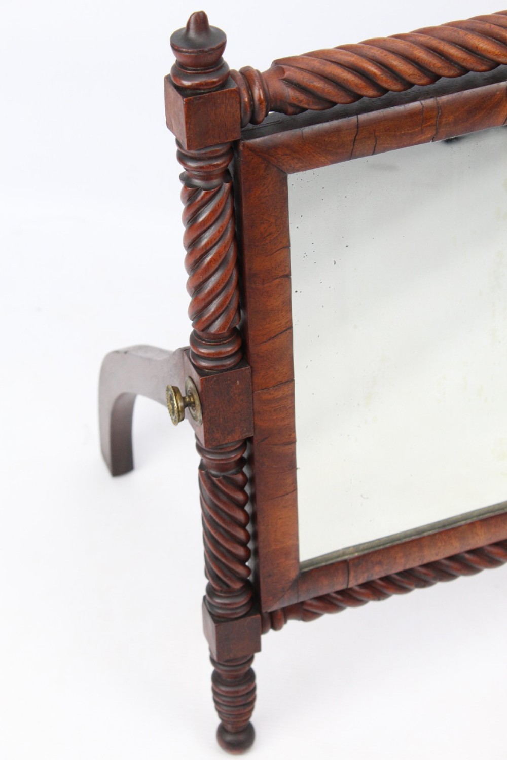 An antique Regency mahogany toilet mirror featuring a swivelling rectangular glass frame supported by rope-twist turned pillars with finials. View VI