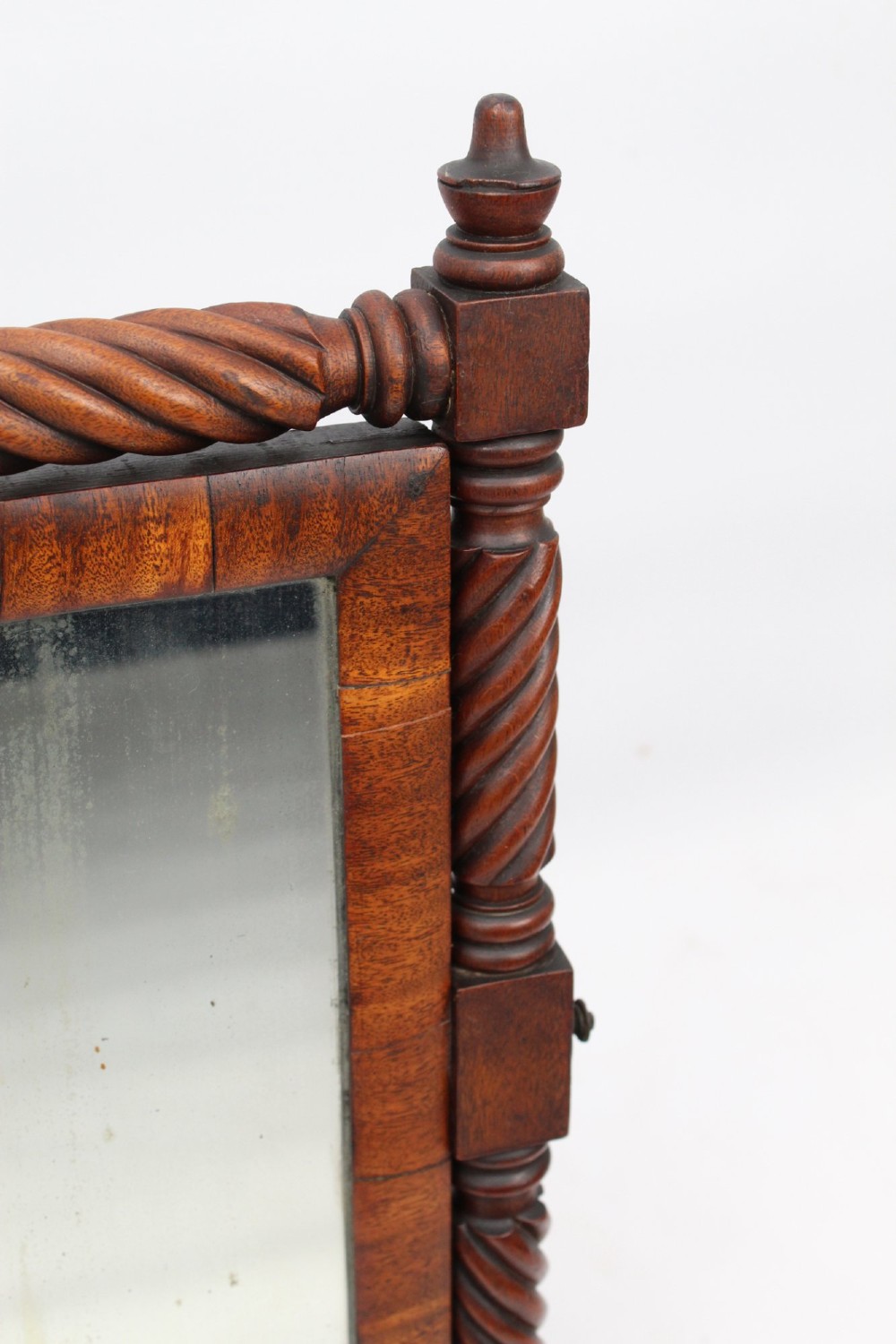 An antique Regency mahogany toilet mirror featuring a swivelling rectangular glass frame supported by rope-twist turned pillars with finials. View VIII