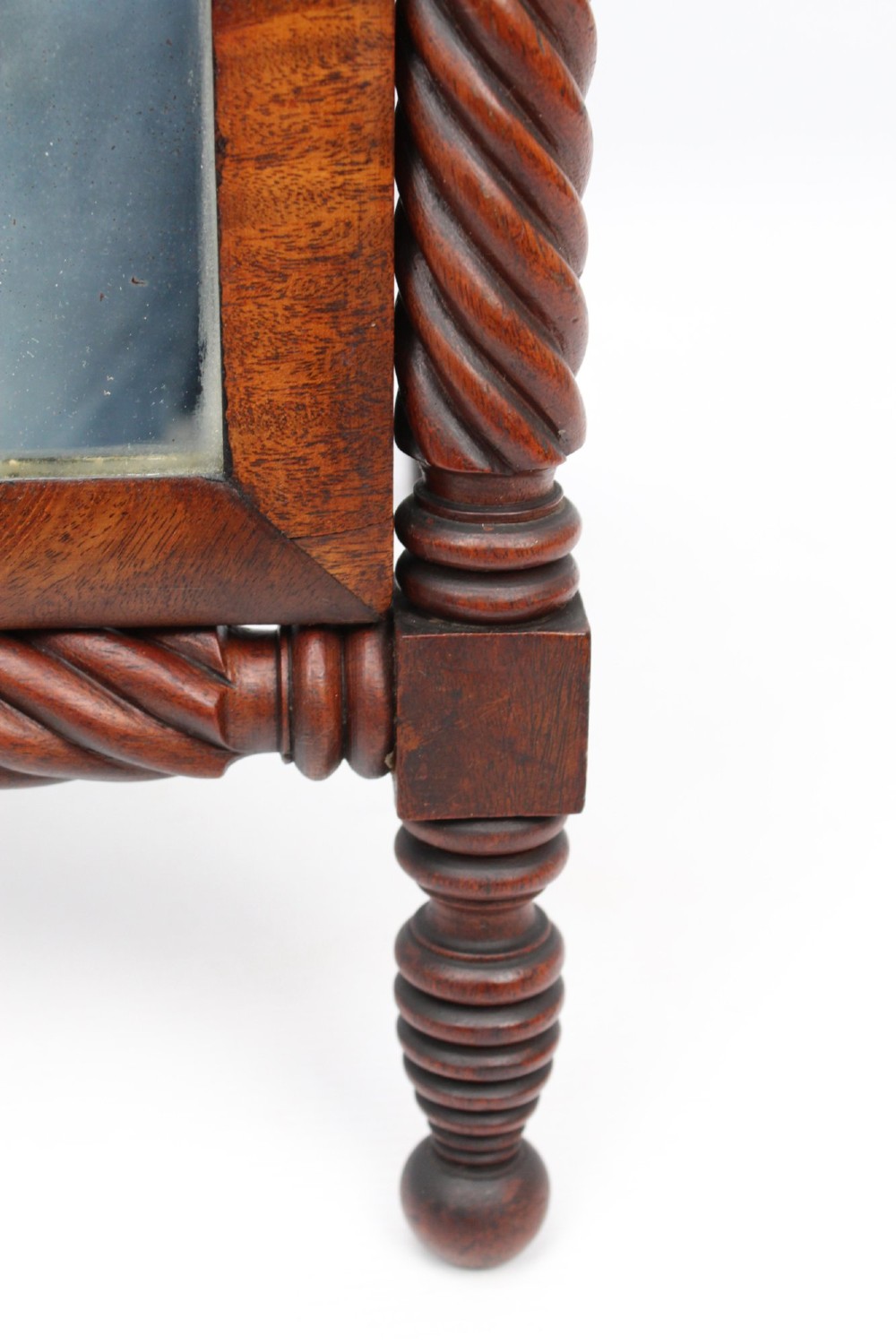 An antique Regency mahogany toilet mirror featuring a swivelling rectangular glass frame supported by rope-twist turned pillars with finials. View IX