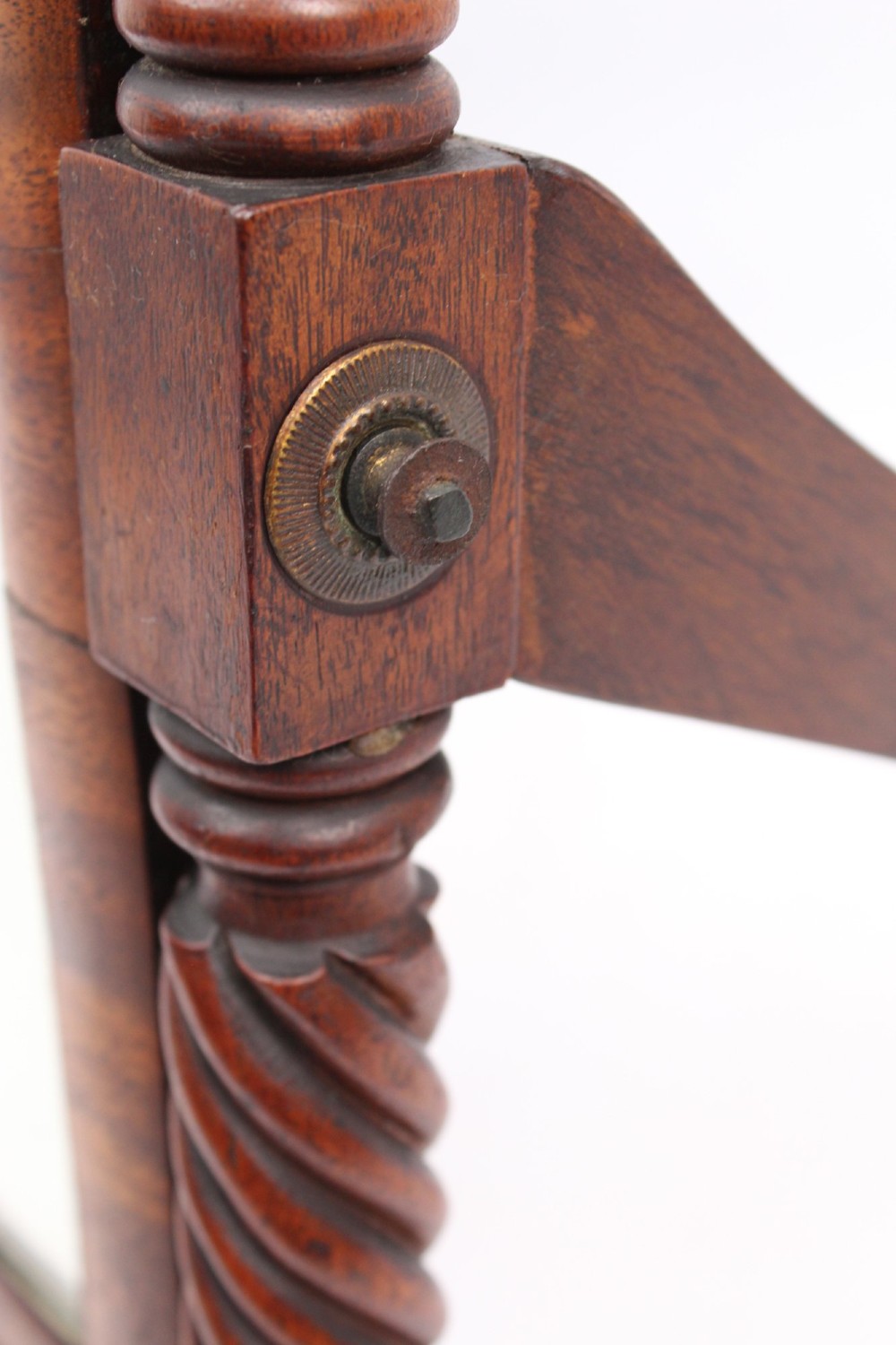 An antique Regency mahogany toilet mirror featuring a swivelling rectangular glass frame supported by rope-twist turned pillars with finials. View XI