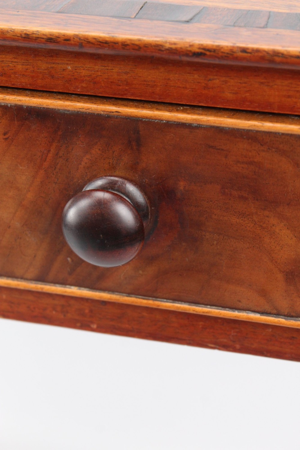 A Regency mahogany writing desk featuring brass inlaid corner stiles, two frieze drawers with wooden knobs, and turned legs. View VII