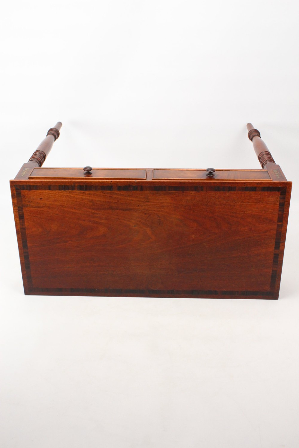 A Regency mahogany writing desk featuring brass inlaid corner stiles, two frieze drawers with wooden knobs, and turned legs. View XII