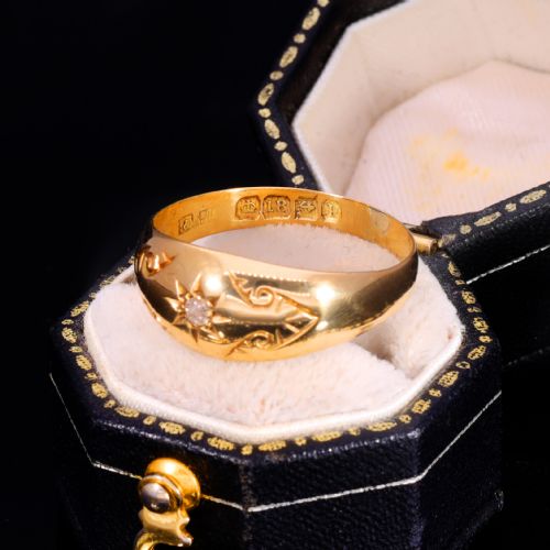 fig 3. An 18ct yellow gold Victorian band ring featuring a starburst-set diamond surrounded by hand-carved scroll engraving and visible internal hallmarks.