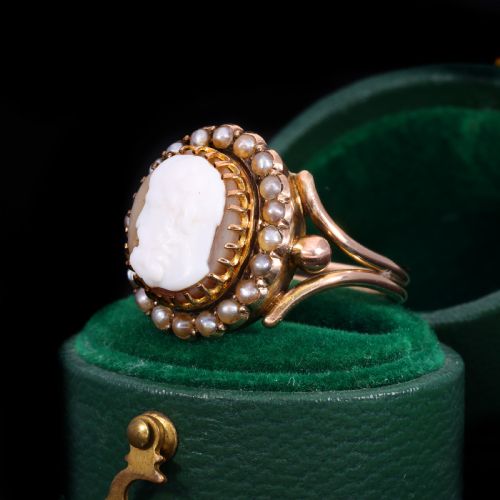fig 2. A Victorian yellow gold ring set with an oval carved shell cameo profile encircled by a halo of seed pearls.