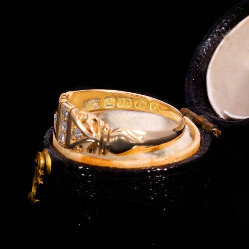 fig 3. An Edwardian yellow gold ring featuring five inset diamonds within an ornate engraved pattern band.