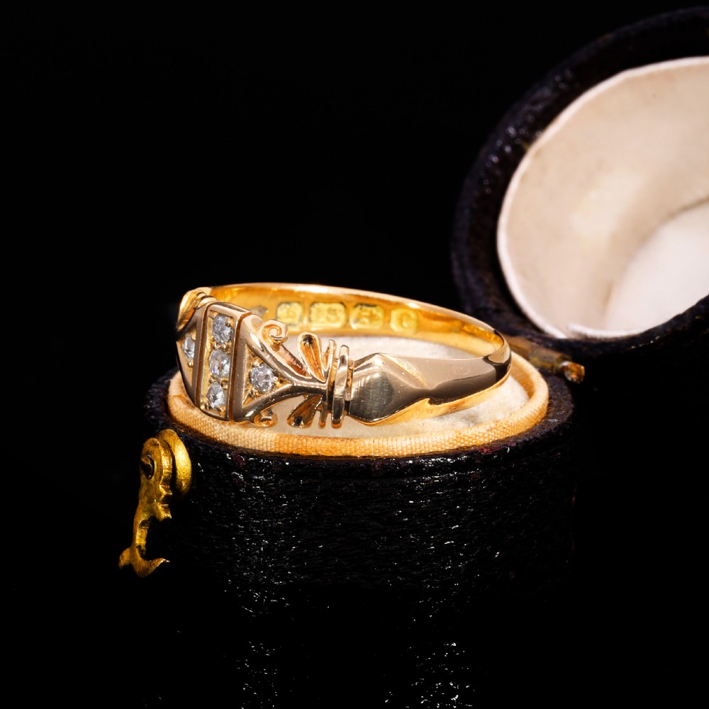 An Edwardian yellow gold ring featuring five inset diamonds within an ornate engraved pattern band. View II