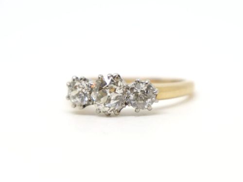 fig 1. A vintage 18ct yellow gold ring featuring three round old-cut diamonds set side by side in claw settings.