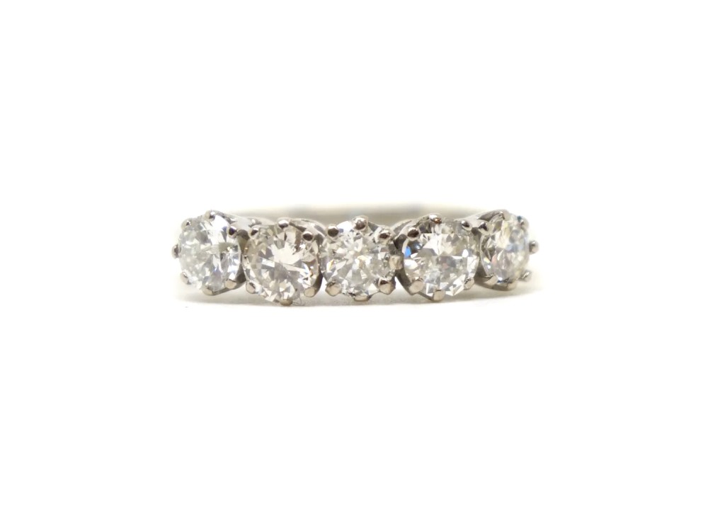 An 18ct white gold ring featuring a horizontal row of five round brilliant diamonds held in individual claw settings.