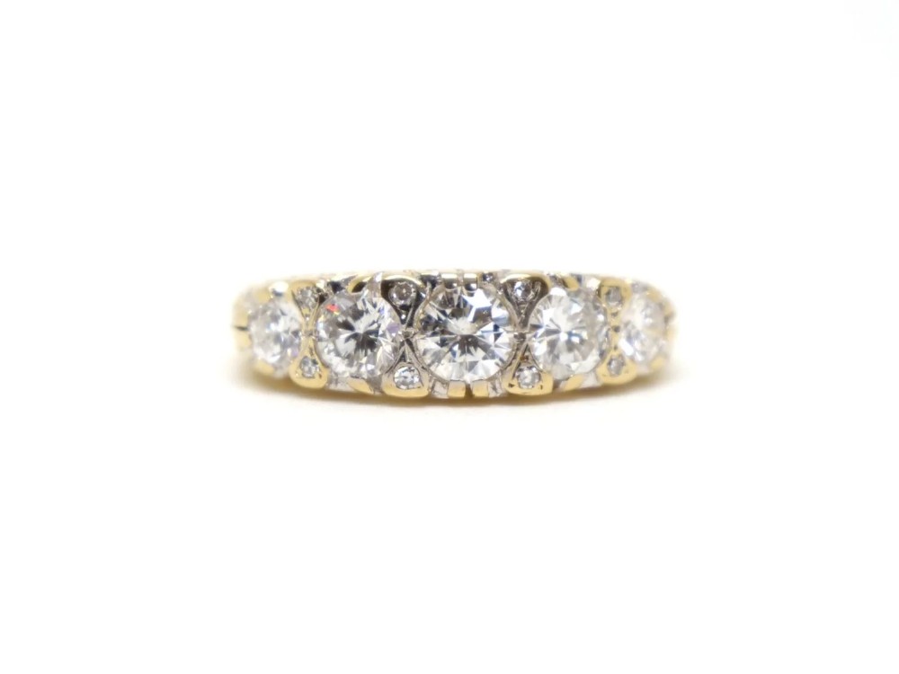 A vintage 18ct yellow gold ring featuring five brilliant-cut diamonds set in a horizontal row across the band.