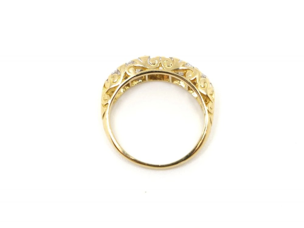 A vintage 18ct yellow gold ring featuring five brilliant-cut diamonds set in a horizontal row across the band. View IV