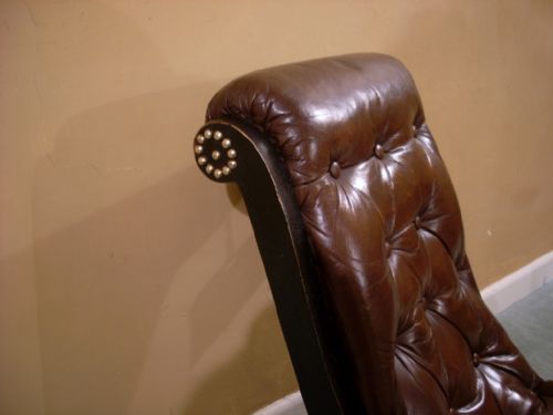 fig 1. A ebonised and leather upholstered easy chair