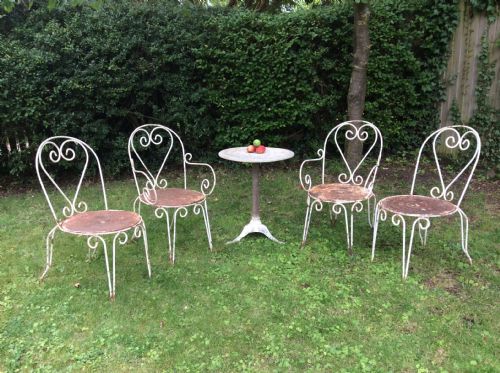 A Table Together with Set of French Iron Garden Chairs