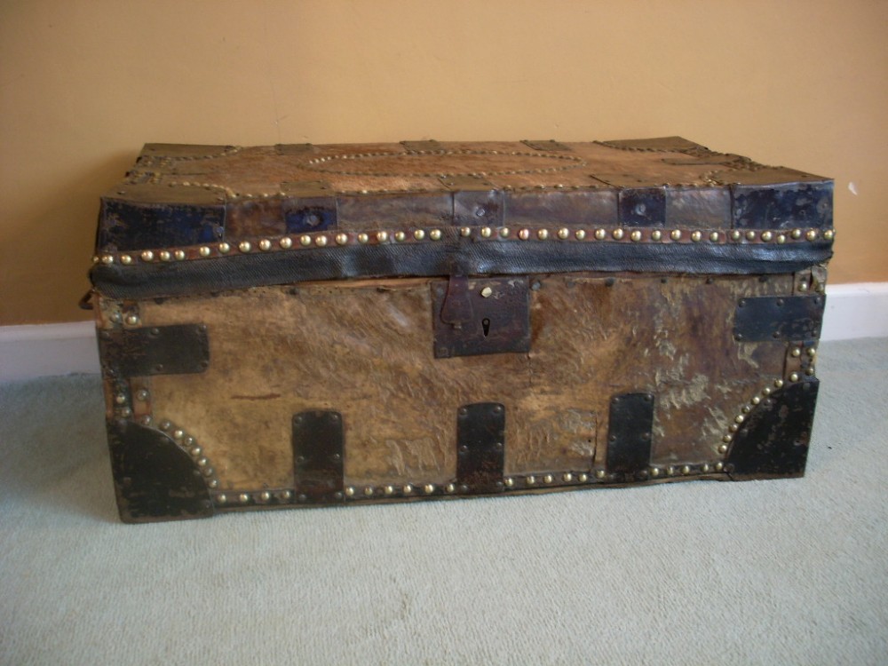 An early 19th leather and iron bound trunk