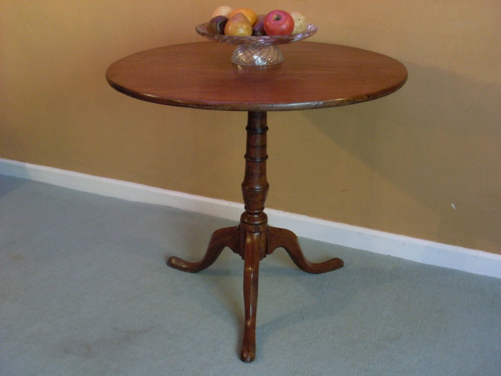 A Georgian oak tilt top tripod table