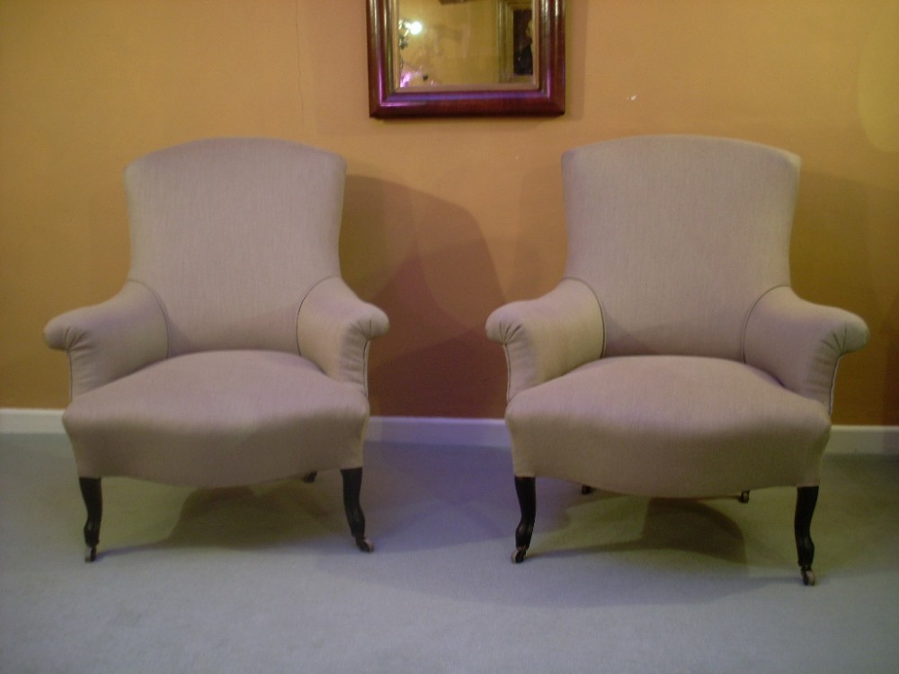 A pair of French upholstered open armchairs