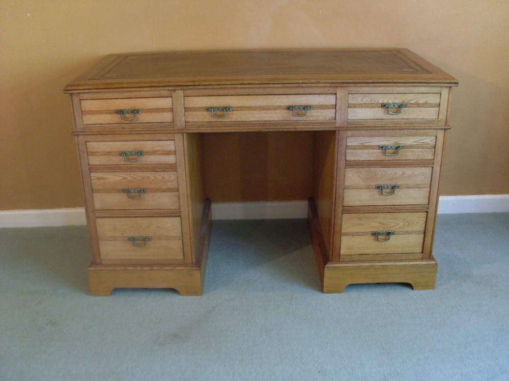An Edwardian light oak desk