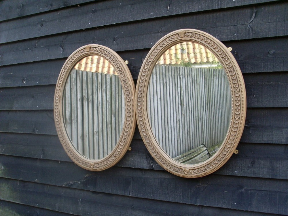 A pair of Victorian oval wall mirrors