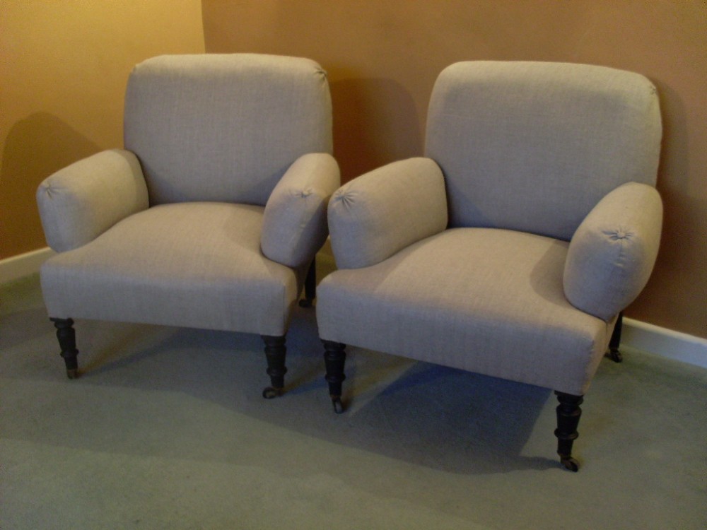 A pair of French Napoleon III low backed armchairs.