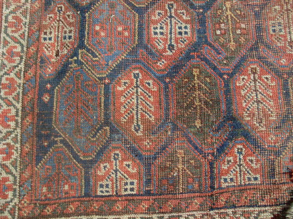 An antique rug 274cm X 145 cm