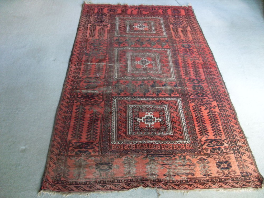 An antique rug 206 x 108 cms