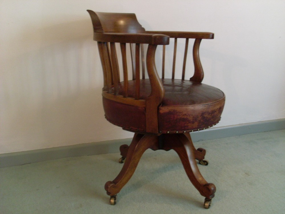 A Victorian revolving desk chair with leather seat